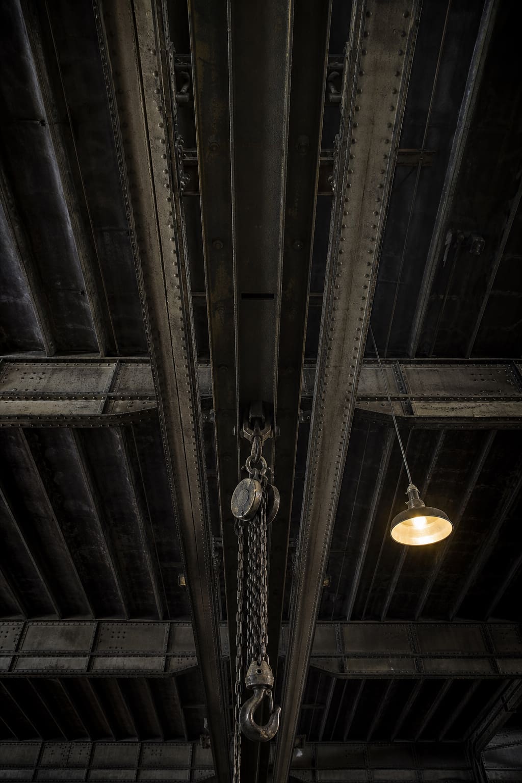 The riveted crane rail and girders on the machine-shop ceiling.